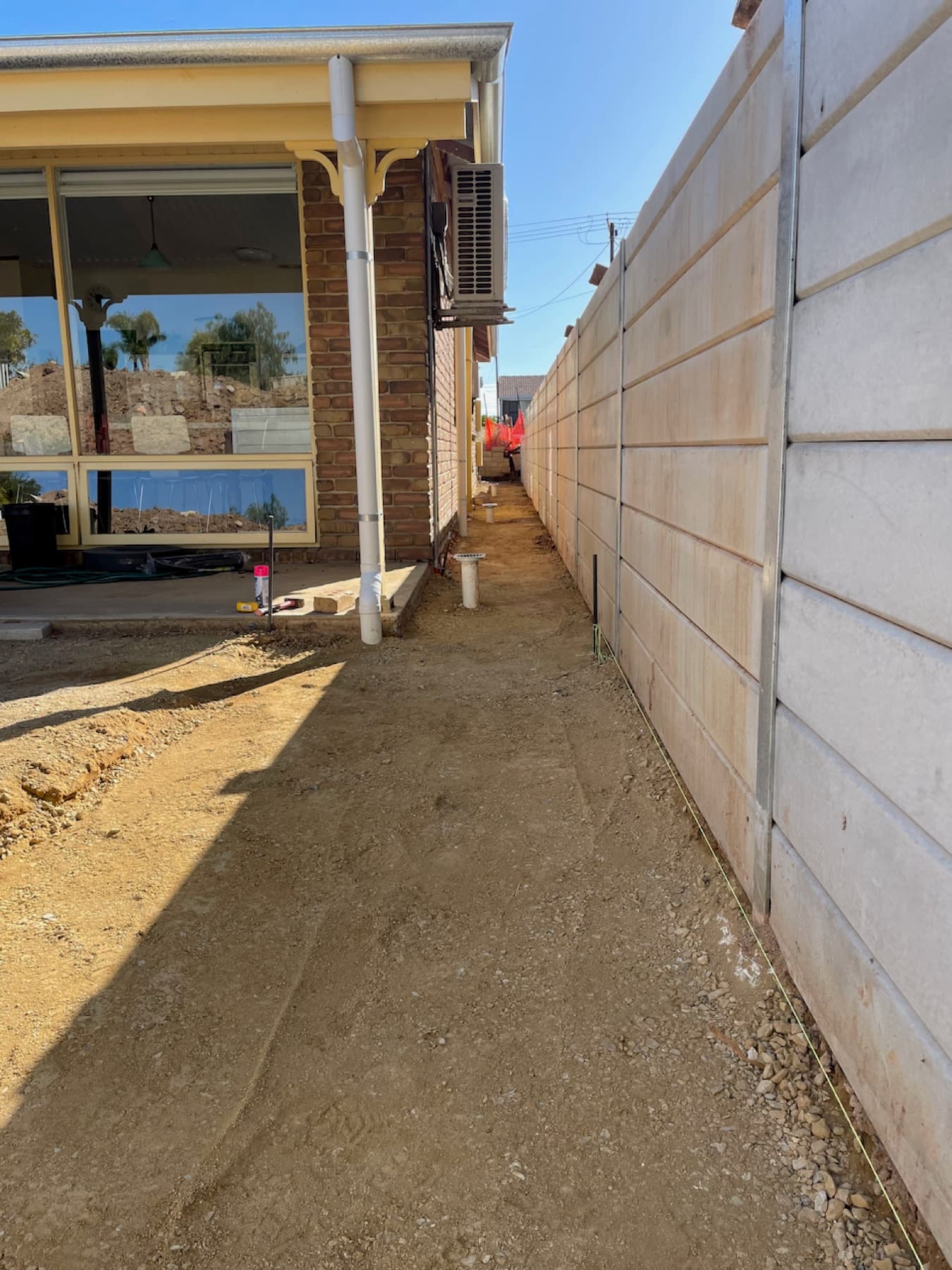 Levelled ground along the side of a house prepared for rainwater tank installation
